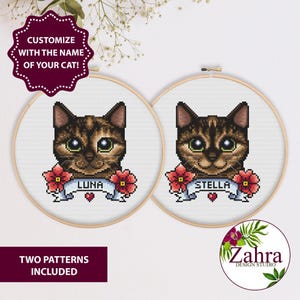 May include: Two cross-stitch patterns in wooden hoops, featuring cat portraits with names "LUNA" and "STELLA" on banners, surrounded by red flowers. The text "CUSTOMIZE WITH THE NAME OF YOUR CAT!" is at the top. The text "TWO PATTERNS INCLUDED" is at the bottom.