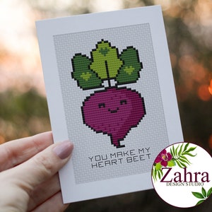 May include: A white card with a cute cartoon beet with a green top and a smiling face. The text "You make my heart beet" is printed below the beet.