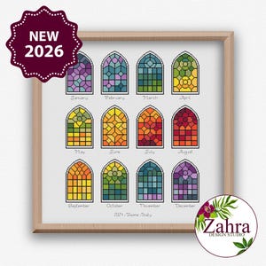 May include: A framed print with twelve stained-glass window designs, each representing a month. The windows are filled with colourful geometric patterns. The print includes the text "NEW 2026" and "2024-Rone-Italy". The Zahra Design Studio logo is in the bottom right.