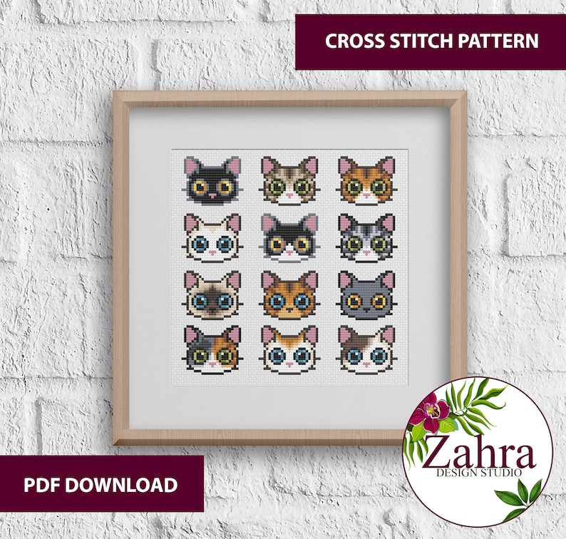 Cross stitch pattern featuring 12 different cat faces with various fur colours and patterns. The pattern is displayed in a framed picture on a white brick wall. The text "CROSS STITCH PATTERN" is at the top of the image and "PDF DOWNLOAD" is at the bottom.