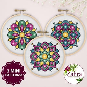 May include: Three cross-stitch patterns in wooden hoops. Each features a colorful geometric design in shades of pink, green, yellow, and blue. The text "3 MINI PATTERNS!" is on a burgundy label. The Zahra Design Studio logo is also visible.