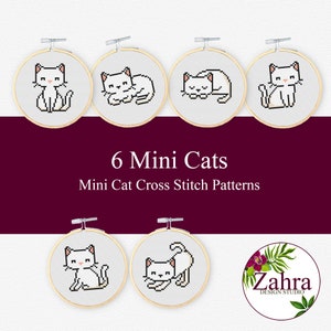 Puede incluir: Seis patrones de punto de cruz de gatitos blancos en miniatura en aros de bordado. Los patrones presentan diferentes poses de los gatos, incluyendo sentados, durmiendo y caminando. El texto "6 Mini Cats" y "Mini Cat Cross Stitch Patterns" se muestra debajo de los aros.