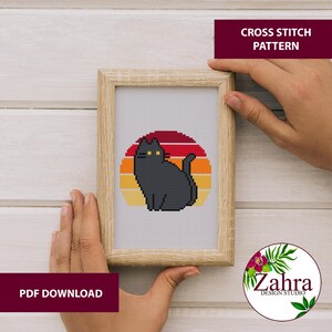 A cute cross stitch pattern with a black cat
