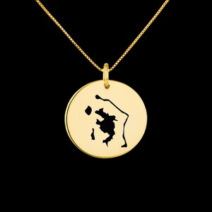Könnte beinhalten: Goldkette mit einem runden Anhänger, der eine ausgeschnittene Silhouette der Insel Saint Lucia zeigt.