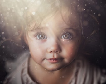 May include: A close-up portrait of a young child with brown hair and big, brown eyes. The child is looking directly at the camera with a curious expression. The background is blurred and out of focus, with a soft, golden light shining down on the child.