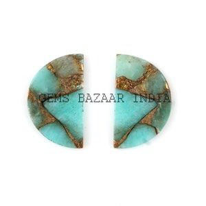 May include: Two half-circle shaped cabochons of green amazonite with gold pyrite inclusions. The stones are cut in a half-round shape and have a smooth, polished surface.