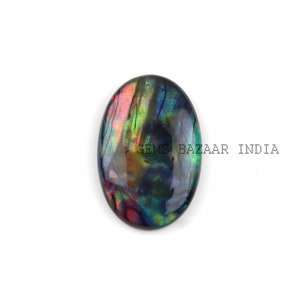 May include: Oval shaped iridescent abalone shell cabochon with a dark blue, green, and red colour pattern.