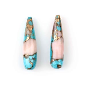 May include: Two teardrop-shaped turquoise and pink gemstone beads with gold flecks. The beads are approximately 1 inch long.