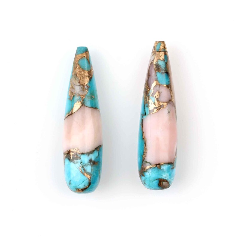 May include: Two teardrop-shaped turquoise and pink gemstone beads with gold flecks. The beads are approximately 1 inch long.