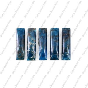 May include: Five rectangular, polished gemstones in shades of blue and teal. The stones have a smooth, reflective surface with natural inclusions. The Gems Bazaar India logo is visible in the background.