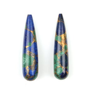 May include: Two teardrop-shaped gemstone pendants with a blue, green, and gold marbled pattern.