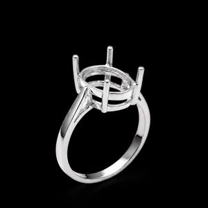 May include: A silver ring setting with a pear-shaped design. The ring features a polished band and prongs to hold a gemstone. The setting is shown against a black background.