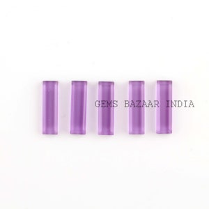 May include: Five purple amethyst rectangular cabochons, each measuring approximately 10mm x 5mm. The stones are smooth and polished, with a slight shimmer. GEMS BAZAAR INDIA.