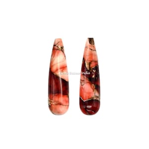 May include: Two teardrop-shaped red, pink, and gold gemstone beads. The beads have a marbled pattern.