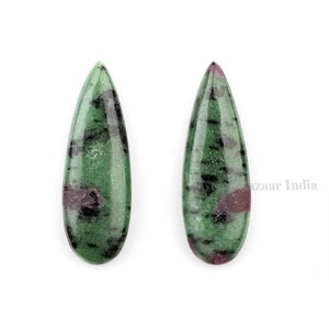 May include: Two green, black, and pink teardrop-shaped gemstones.