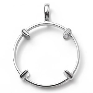 May include: A silver pendant with a circular design. It has a loop for a chain and four pointed accents around the circle. The pendant is made of a shiny, reflective metal. The design is simple and elegant.