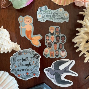 May include: A set of five stickers featuring illustrations of a mermaid, a group of people, a bird, and two wreaths with text that reads "we talk it through, as a crew" and "It's not about glory... It's about belonging to something".