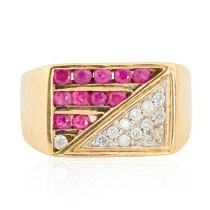 May include: A gold ring featuring a rectangular design with three rows of pink gemstones and a triangular section of white gemstones. The ring has a polished finish and a classic style.