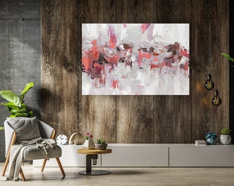 May include: Abstract art print with a palette of red, pink, and gray hues. The artwork is displayed above a modern white cabinet. A gray armchair with a blanket, a small round table, and decorative plants complete the interior design.