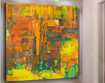 May include: Abstract painting with bold strokes of yellow, orange, green, and red paint. The painting is hanging on a wall in a room with white walls and a white tiled floor. Two white ottomans with metal legs are in front of the painting.