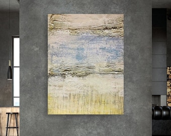May include: Abstract painting with layers of light blue, yellow, and white paint. The painting has a textured surface and is framed in a simple black frame.