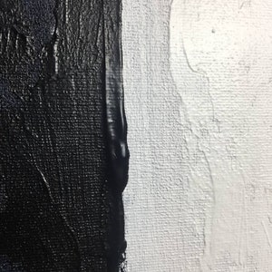 May include: Abstract painting with a vertical line dividing the canvas. The left side is painted in black with a textured brushstroke. The right side is painted in white with a smooth brushstroke.