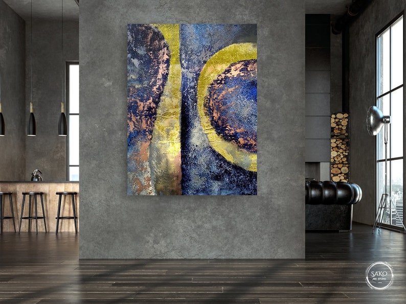 May include: Abstract painting with blue, gold, and copper tones. The painting features a series of overlapping circles and lines.