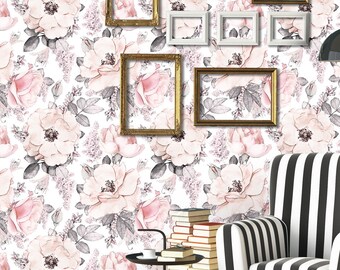 May include: A room with floral wallpaper featuring large pink and gray flowers. A black and white striped armchair sits in front of the wall, with a black floor lamp and framed pictures. The floor is made of wooden planks.