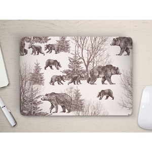 May include: A laptop skin with a repeating pattern of brown bears and trees on a white background.