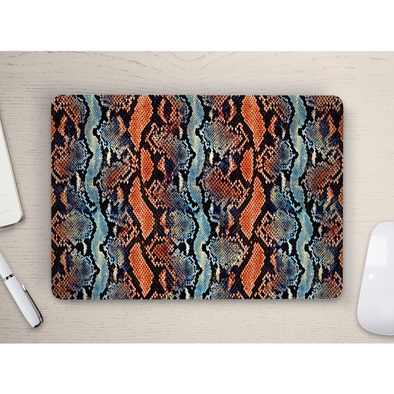 May include: A laptop skin with a snakeskin pattern in shades of blue, orange, and black.