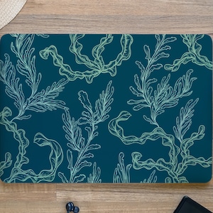 May include: A laptop skin with a teal background and a white outline of seaweed.