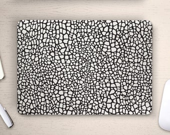 May include: Black and white laptop skin with a textured pattern resembling scales or a reptile skin.