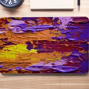 May include: Abstract painting with thick brushstrokes in shades of purple, yellow, orange, and red. The painting has a textured surface and a modern style.