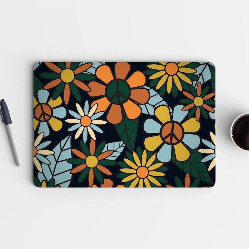 May include: A laptop skin featuring a psychedelic pattern of flowers and peace signs in shades of orange, yellow, blue, and green on a dark blue background.
