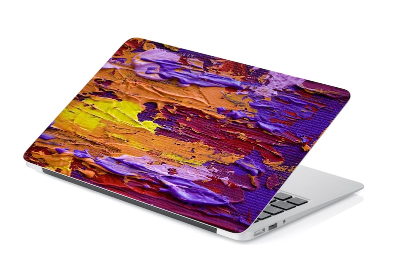 May include: A laptop computer with a colorful abstract design on the lid. The design features shades of purple, yellow, orange, and red.