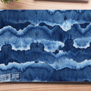 May include: Blue and white abstract watercolor pattern laptop skin. The skin features a repeating pattern of blue and white waves. The skin is designed to fit a standard laptop.