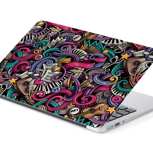May include: A laptop computer with a colourful, doodle-style design featuring musical instruments, notes, and other music-related imagery. The design includes a guitar, microphone, drums, and a piano keyboard.