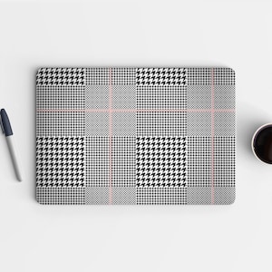 May include: A black and white houndstooth laptop skin with a thin red line pattern.