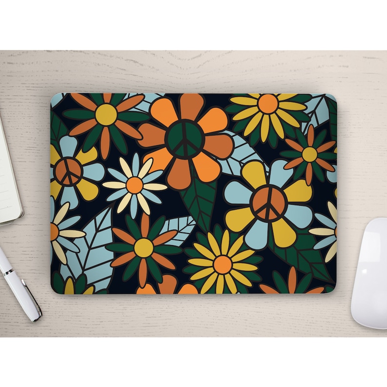 May include: A laptop skin with a retro 70s style floral pattern. The design features colourful flowers with peace signs in the centres, set against a dark blue background.