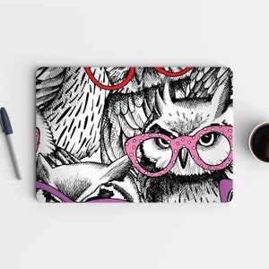 May include: A black and white illustration of three owls wearing glasses. The owl in the foreground is wearing pink glasses with white polka dots. The owls are drawn in a detailed and intricate style.