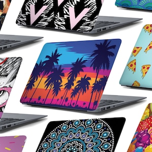 May include: A collection of laptop skins featuring a variety of designs, including a black and white zebra print with a pink letter V, a blue and orange sunset with palm trees, a blue and white mandala pattern, a blue and green geometric pattern, a blue background with pizza slices, and a colourful fruit and candy pattern.