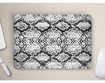 May include: A laptop skin with a black and white snake skin pattern.