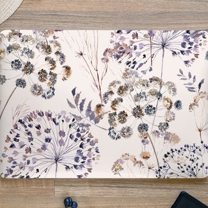 May include: A laptop skin with a watercolor design of purple and brown wildflowers on a white background.