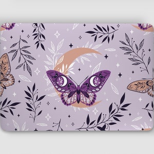 May include: Purple and gold butterfly with moon and stars on a lavender laptop skin. The butterfly has a crescent moon design on its wings.