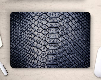 May include: A close-up of a dark blue snakeskin pattern. The texture is embossed and has a subtle sheen.