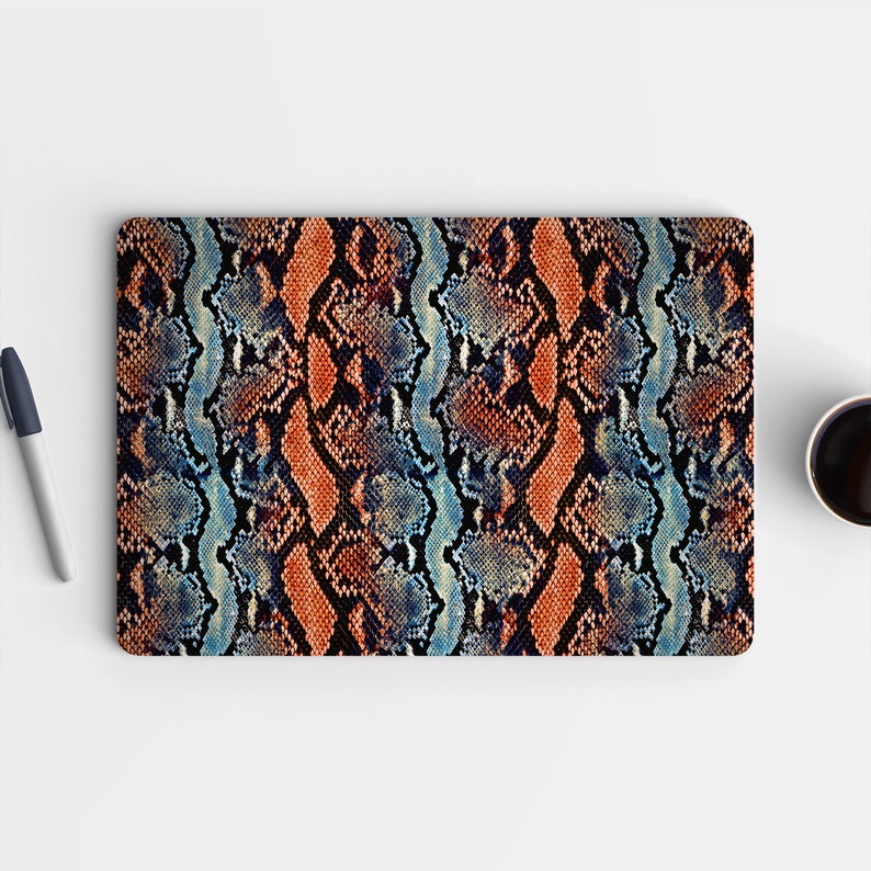 May include: A laptop skin with a snakeskin pattern in shades of blue, orange, and black.