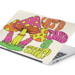 May include: A laptop skin with a psychedelic design featuring three cartoon mushrooms and the text "Let's Take a Trip!" in a retro font.