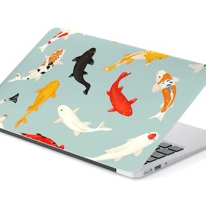 May include: A laptop computer with a light blue cover featuring a repeating pattern of colorful koi fish. The fish are swimming in different directions and are depicted in a stylized, cartoon-like manner.