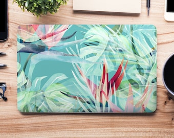 May include: A laptop skin with a tropical leaf design. The design features large green leaves with red and pink accents on a teal background.