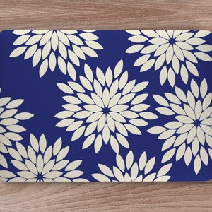 May include: A laptop skin with a navy blue background and a repeating pattern of white stylized flowers.